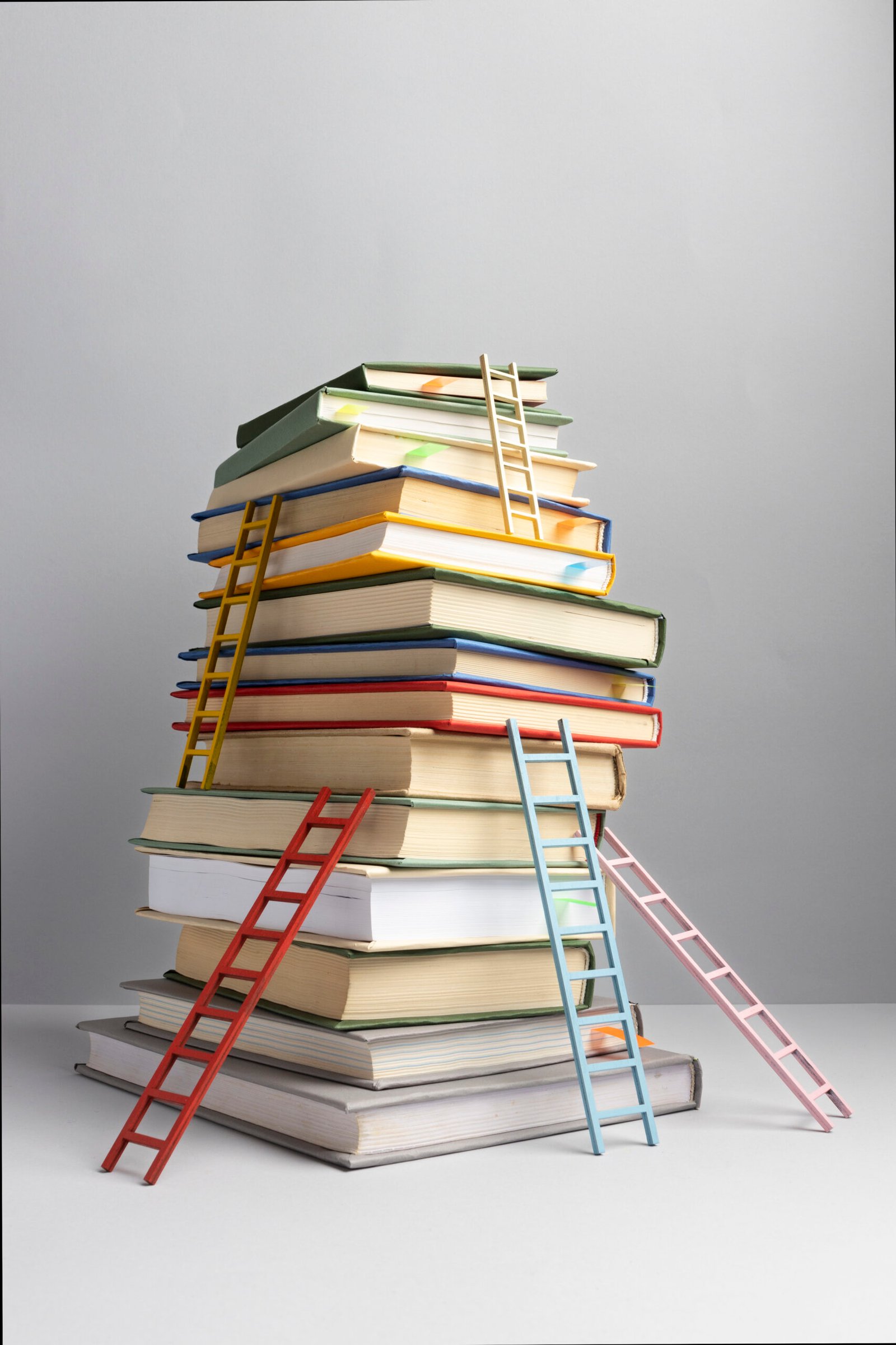 front view stacked books ladders with copy space education day